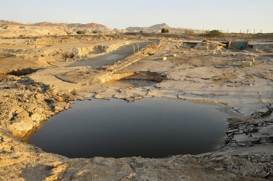 One of the so-called "sink holes" on the shore of the Dead Sea, undergound collapse caused by the water recession, near Safi, Jordan, Middle East, Orient