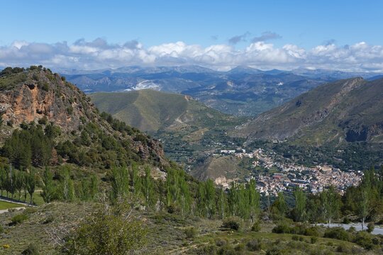 Panoramic landscape with mountains, a valley and a village, surrounded by greenery and under a clear sky, mountain village G&uuml;&eacute;jar Sierra, G&uuml;ejar, Granada province, Andalucia, Spain