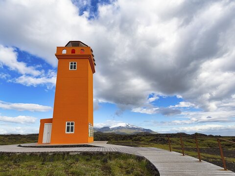Orange lighthouse Sk&aacute;lasnagaviti or Sv&ouml;rtuloft with wooden boardwalk, &Ouml;ndver&eth;arnes, Sn&aelig;fellsnes Peninsula, Iceland