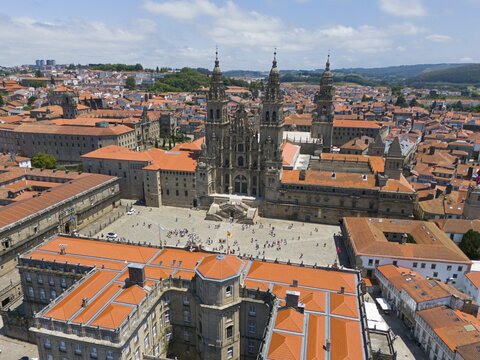 City view with focus on a magnificent cathedral in the centre, surrounded by other historic buildings with red roofs, aerial view, cathedral, Santiago de Compostela, autonomous community of Galicia, place of pilgrimage, destination of the Way of St. James, Spain