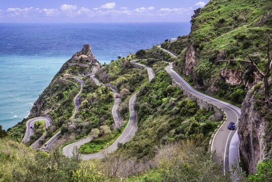 Mountain road to the village with serpentines and the Castello di Sant Alessio Siculo above the sea, Forza d Agro, East Coast, Sicily, Italy