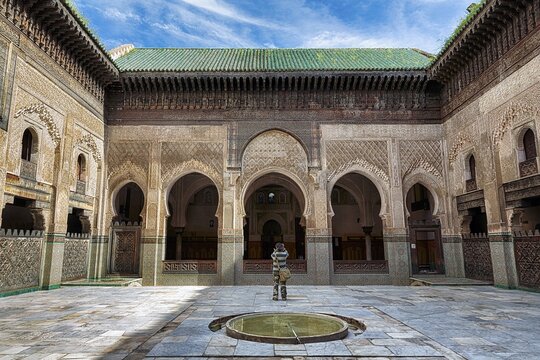 Inner courtyard with water basin, visitors photographing wooden facades and arcades, ornaments, 14th century Islamic college, Medersa Bou Inania, Fes el Bali, UNESCO World Heritage Site, Fez, Fez-Mekn&egrave;s, Morocco