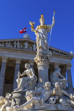 Pallas-Athena Fountain, The goddess of wisdom, holding a spear in her left hand, the goddess of victory Nike in her right hand, behind her the building of the parliament, Vienna, Austria