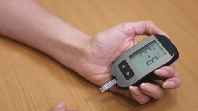Glucometer. Gadget. Medicine. Woman's hand. Slow motion.. High quality 4k footage