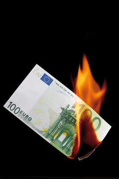 100 euro note burning against black background