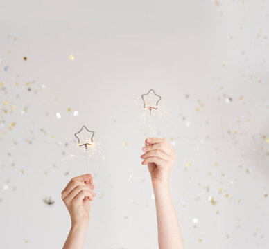 Woman's hands holding sparklers