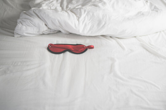 Eye mask in rumpled bed