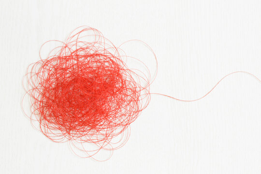 Red thread on white background