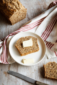 Home.baked spelt bread with flax and sesame, slice with butter