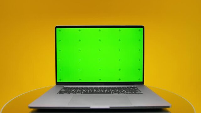Laptop With Green Screen On Yellow Background