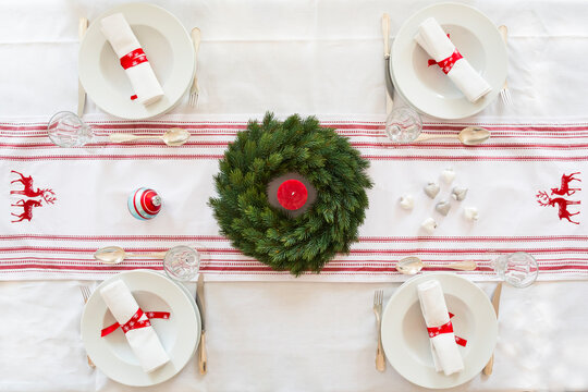 Red-white laid table with Advent wreath at Christmas time