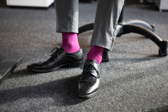 Close-up of businessman in office wearing pink socks