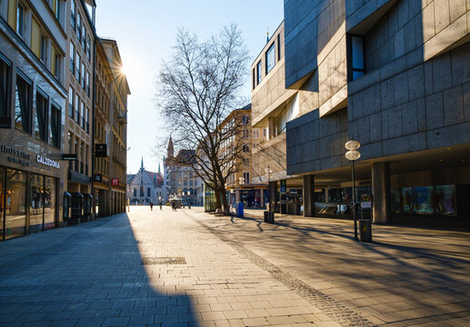Germany, Bavaria, Munich, Sun shining over empty Neuhauser Strasse street
