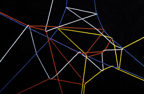 Connected threads in front of black background