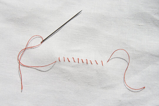 Red seam on white cloth, close-up