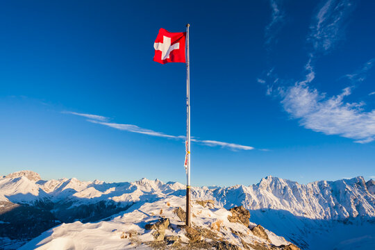 Switzerland, Graubuenden, Savognin, Mountaintop Piz Martegnas, swiss flag