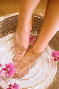 Woman taking footbath, low section, elevated view