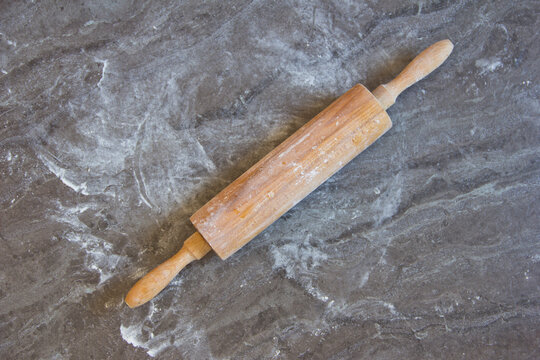 Rolling pin on floured kitchen worktop