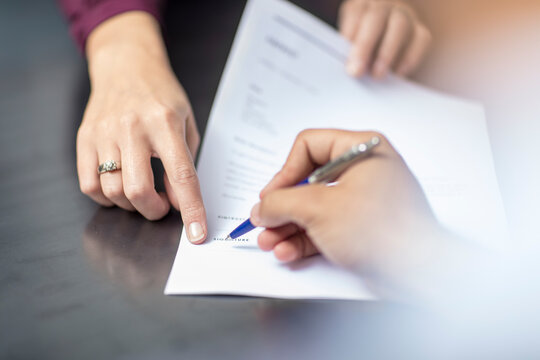 Close-up of signing a document