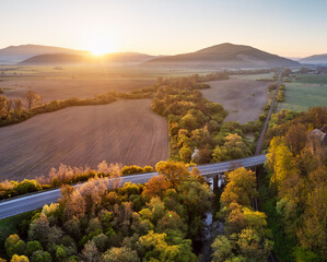 Fototapeta premium Sunrise in Slovakian countryside with forest
