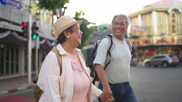 Asian senior couple traveler traveling and exploring the city outdoors. 