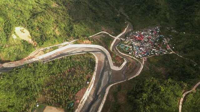 Panoramic aerial overview of Barangay Obi in Caramoran, Catanduanes, featuring a riverbank village framed by lush tropical mountains