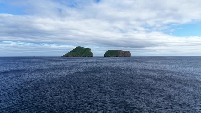 Drone shot of Ilheus das Cabras volcanic islets surrounded by the Atlantic Ocean near Terceira Island in the Azores Portugal