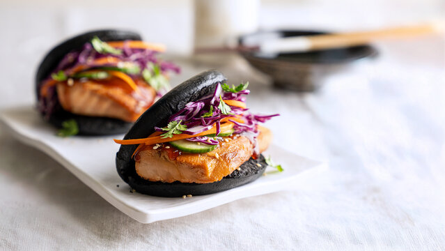 Salmon bao buns with purple cabbage slaw and copy space, Asian fusion food banner