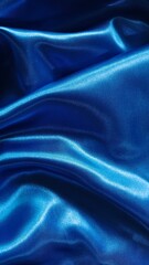 Fototapeta premium Luxurious royal blue satin fabric shimmers with elegant folds, creating a rich and sophisticated abstract texture.