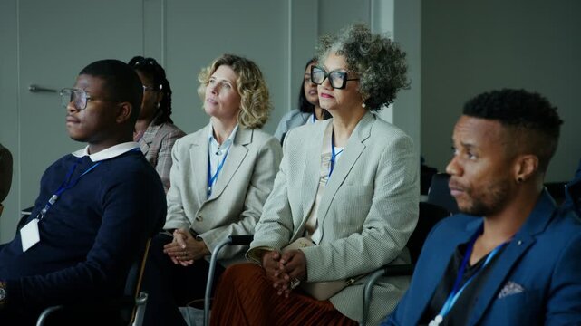 Attentive professionals and business people are engaged in a productive conference or seminar. The diverse audience focuses on the speaker, absorbing valuable information and gaining insights.