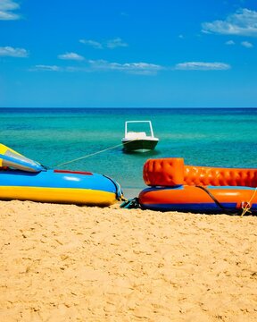 Hammamet, Tunisia - MAY 16, 2025: Beach of Hammamet, the first tourist destination in Tunisia. Located on the Gulf of Hammamet. Beach and boats on shallow water, view on Mediterranean sea. Crystal-cle