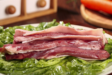 Fototapeta premium Fresh Raw Ningxia Grassland Lamb Meat Strips on Lettuce for Traditional Chinese Cuisine