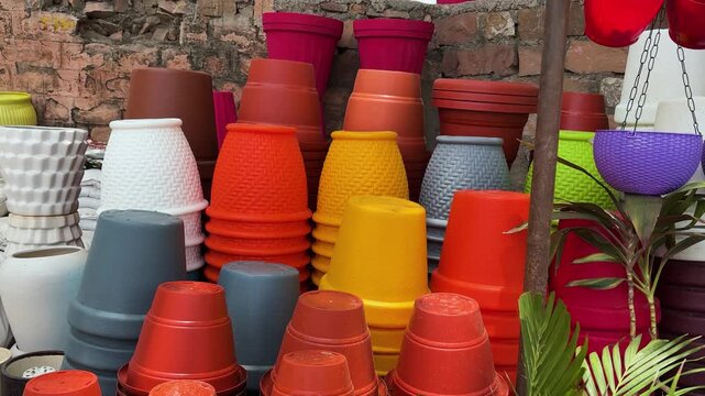 colorful plastic flower pots displayed at outdoor garden supplies market stall
