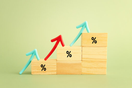 Wooden cubes with percentage sign going up, concept of business growth, finance and income increase