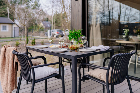 Cozy weekend lunch table prepared on cabin terrace