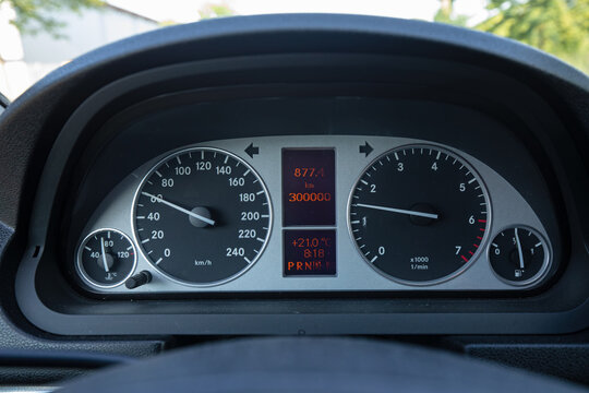 Close-up of a Mercedes-Benz B-Class car dashboard showing a milestone of 300,000 kilometers driven. Modern vehicle instrument cluster with speedometer, tachometer, and digital display.