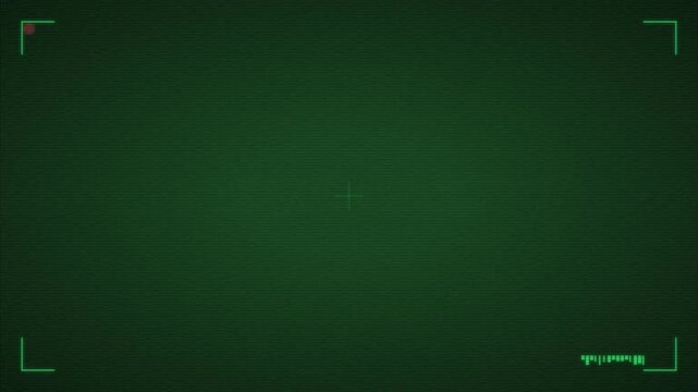 Shadow figure on green night vision surveillance monitor backdrop