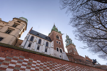 Fototapeta premium Krakow castle area under blue sky with brick wall and architecture at sunrise