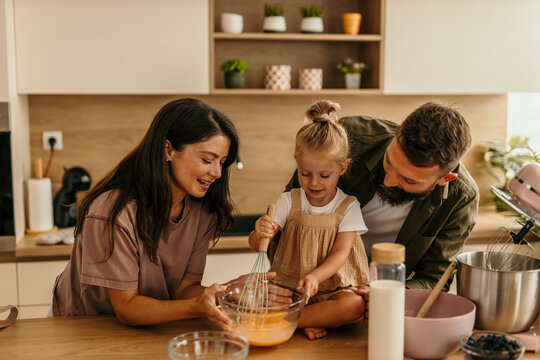 Happy family baking together in modern kitchen
