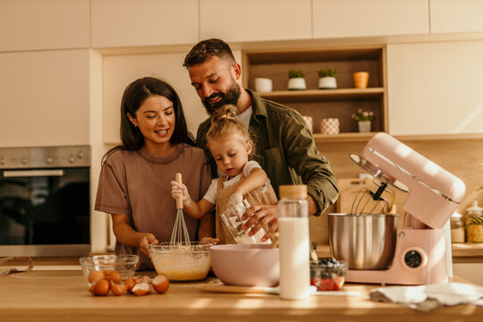 Happy family baking together in modern kitchen