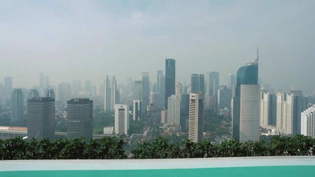 High altitude view of a vast metropolitan cityscape covered in soft morning fog