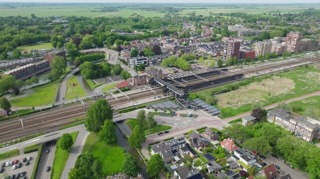 Aerial Woerden train station with train tracks close to city in urban area in Netherlands