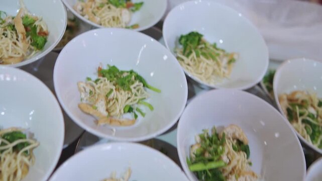 Rows of fresh salad bowls arranged neatly for a large luxury buffet service