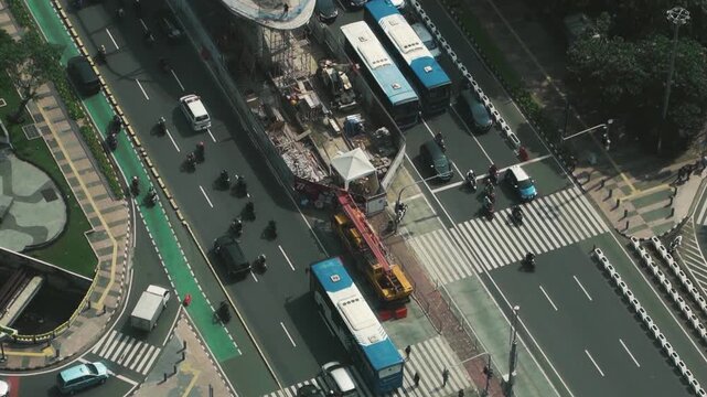 Drone flight rushing forward above a massive urban highway interchange with fast moving traffic