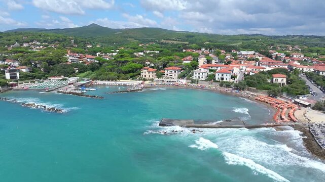 long waves washing over the beaches of Castiglioncello, Italy, warm Tuscan playground for the wealthy