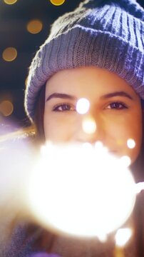 Young woman with a sparkler enjoying time for Christmas