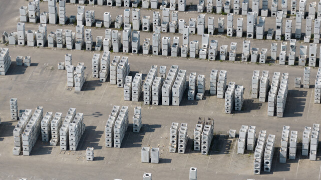 Aerial view of rows of stacked precast concrete drainage elements and industrial building components in an outdoor storage yard Oosterhout, North Brabant, Netherlands.