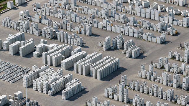 Aerial view of rows of stacked precast concrete elements and industrial building materials in a large storage yard Oosterhout, North Brabant, Netherlands.