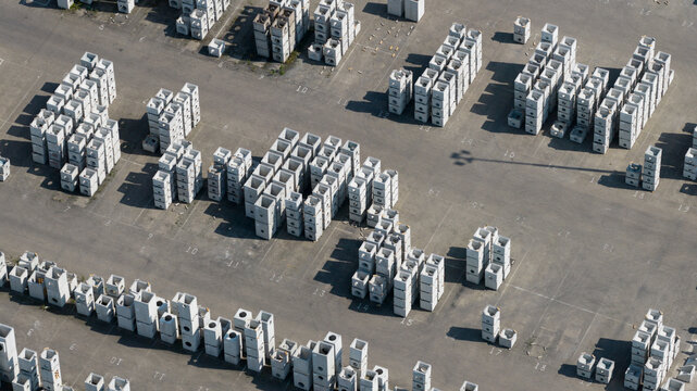 Aerial view of stacks of precast concrete blocks and drainage components organized in a storage yard Oosterhout, North Brabant, Netherlands.