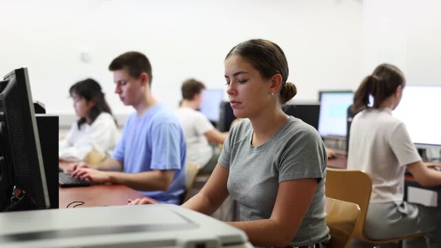 Portrait of smiling caucasian teen schoolgirl in the computer class of the school. High quality 4k footage